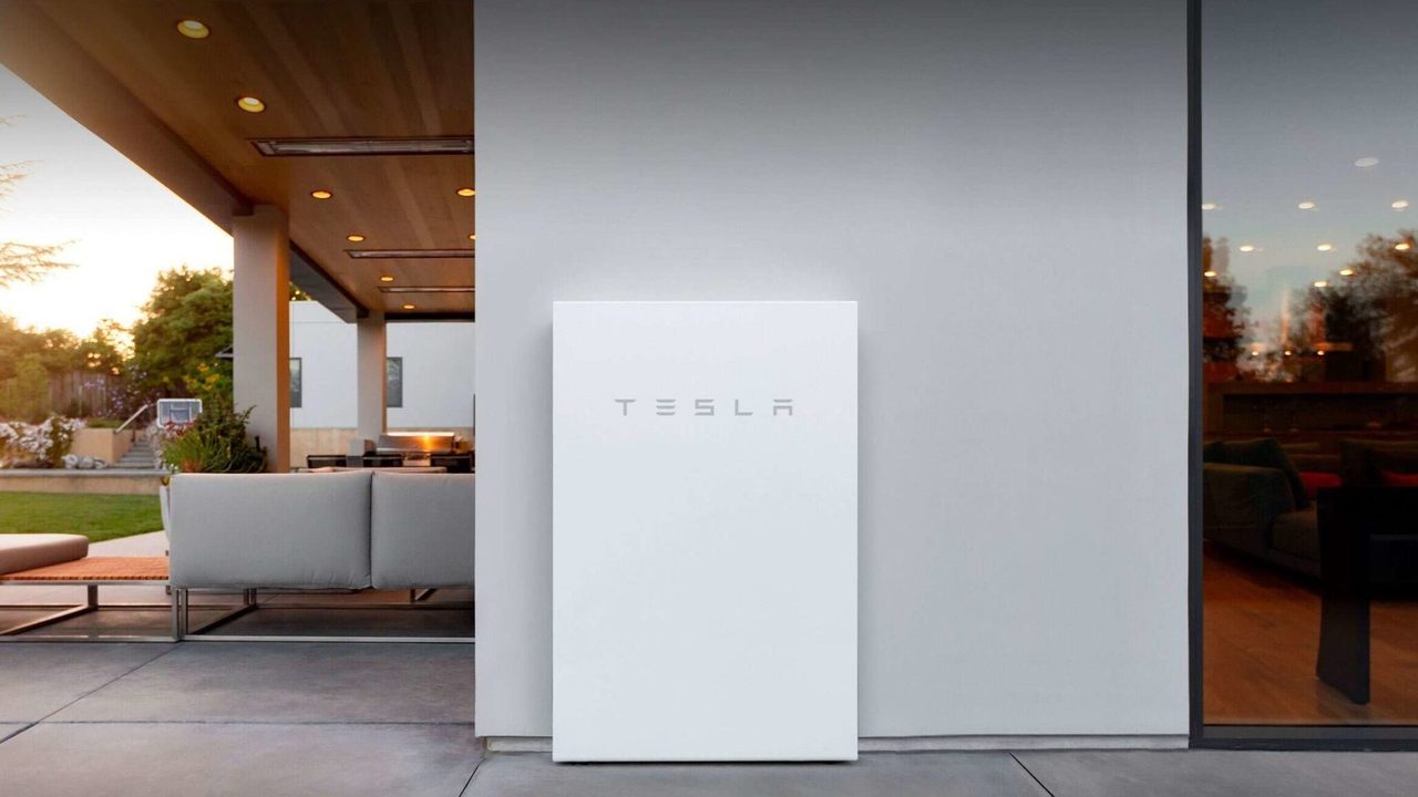 A Tesla Powerwall home battery mounted on a wall